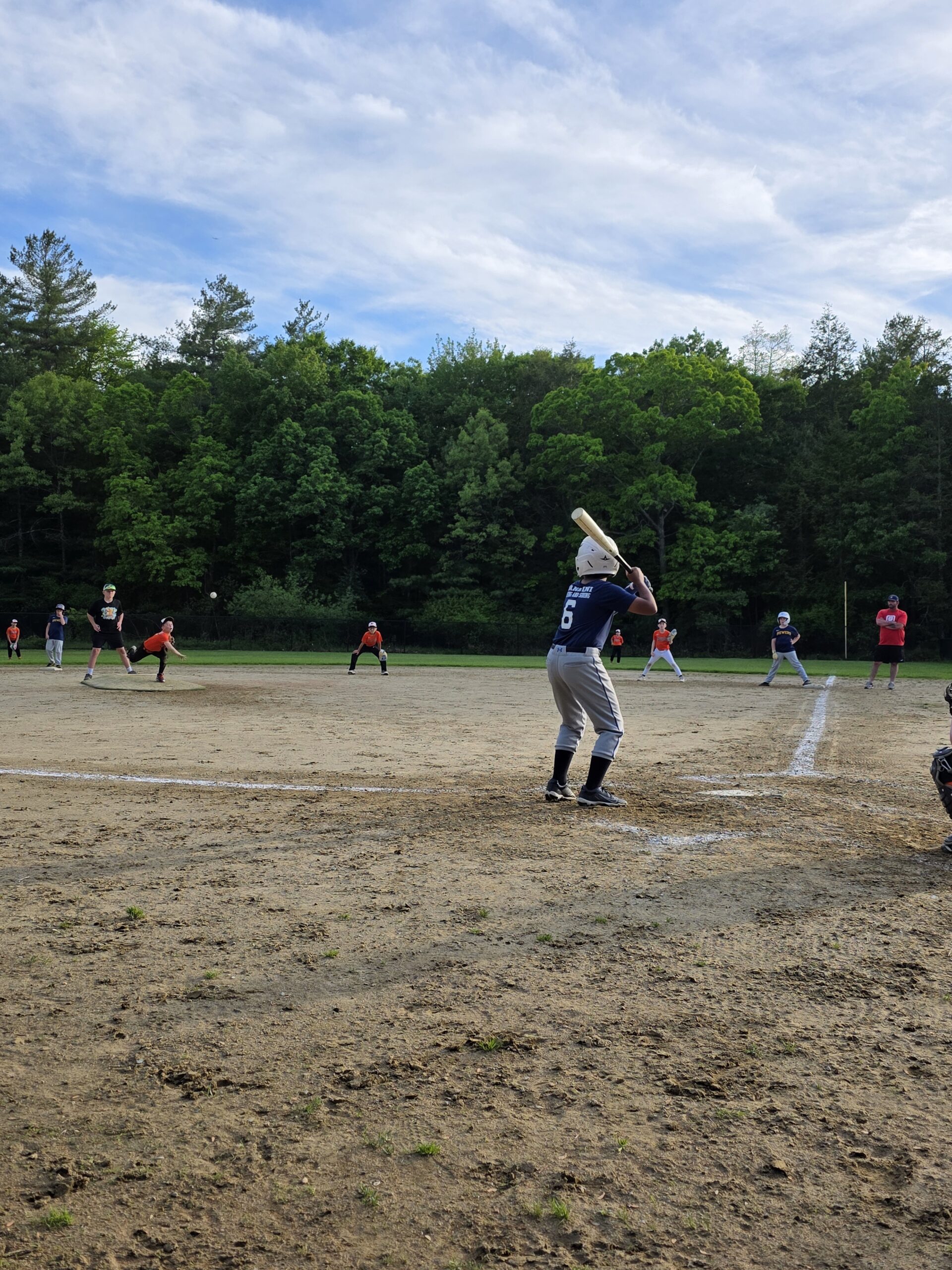 Abington Little League player in Giannini Roofing jersey at bat during a home game